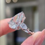 Pear cut lab grown diamond three stones engagement ring