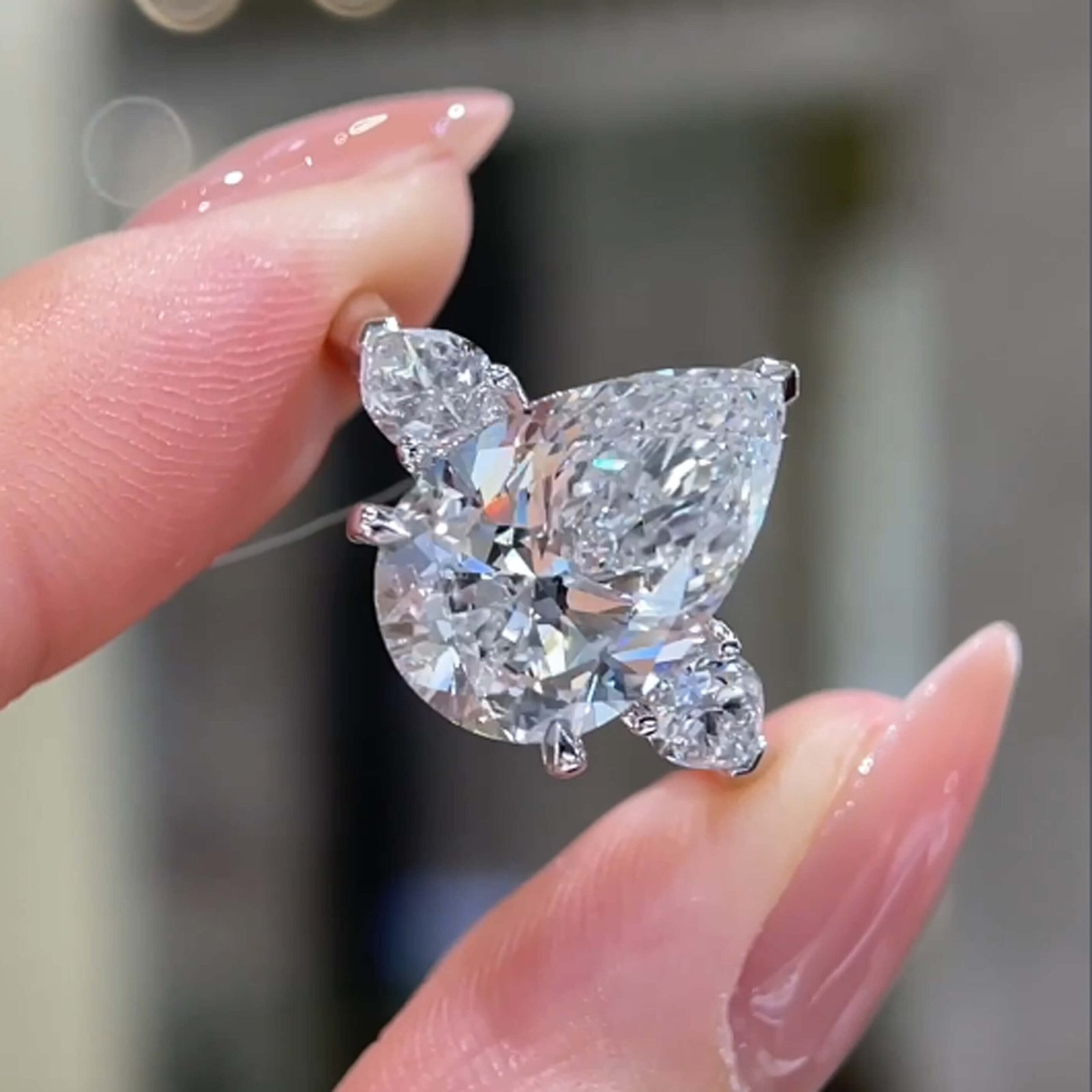 Pear cut lab grown diamond three stones engagement ring
