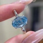 Oval cut lab grown blue diamond engagement ring