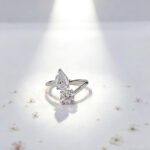 Round and pear cut lab grown diamond engagement ring