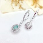 Halo setting oval cut lab grown green diamond hoop earrings